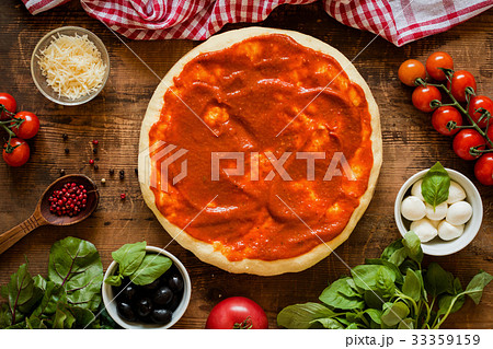 Pizza dough with tomato sauce and igredients for 33359159