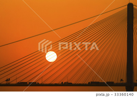 Silhouette of a bridge under setting sun 33360140