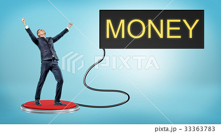 A victorious businessman stands on a large red A victorious businessman stands on a large red 33363783