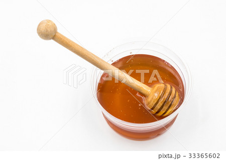 Honey with wood stick on white background. Honey with wood stick on white background. 33365602