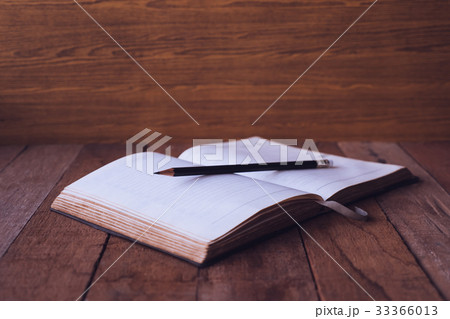 Blank notebook with pencil on wooden table. Blank notebook with pencil on wooden table. 33366013