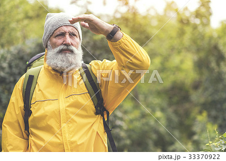 Thoughtful senior male traveler looking at natural Thoughtful senior male traveler looking at natural 33370922