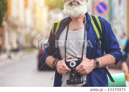 Joyful senior male tourist photographing town Joyful senior male tourist photographing town 33370973