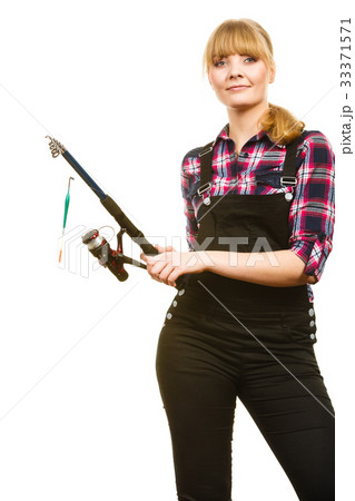 Similing woman wearing check shirt holding fishing rod 33371571