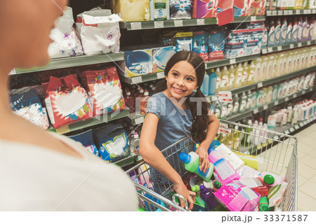 Brightly smiling female child doing shopping with 33371587