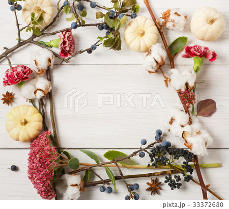 Autumn frame of dried flowers on white wood Autumn frame of dried flowers on white wood 33372680