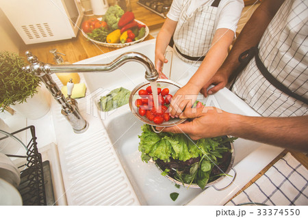 Father with son washes vegetables before eating 33374550
