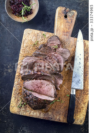 Roast Venison Sliced on Cutting Board 33374965