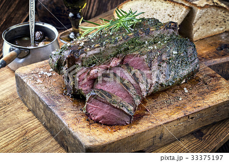 Barbecue Saddle of Venison on Cutting Board 33375197