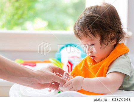 Happy little baby boy eating food 33376643