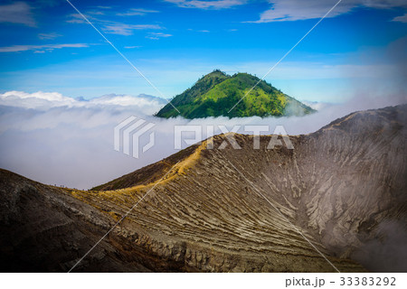 Landscape of mountains amount fog in Kawah Ijen 33383292