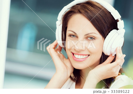 Woman in headphones Woman in headphones 33389122