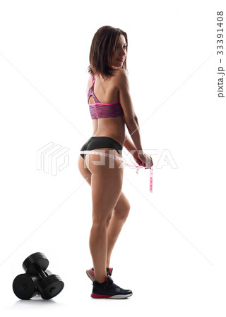 Beautiful sportswoman measuring her body after 33391408