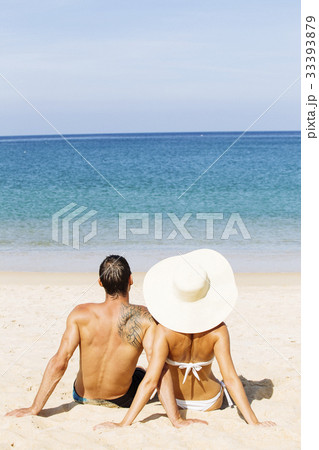 A couple sunbathing together on the beach in summer 33393879