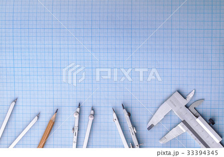 Measuring instruments on top of blue graph paper 33394345