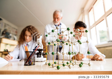 Senior teacher teaching biology to high school Senior teacher teaching biology to high school 33395679