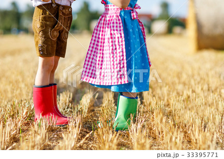 Two kids in traditional Bavarian costumes and red Two kids in traditional Bavarian costumes and red 33395771