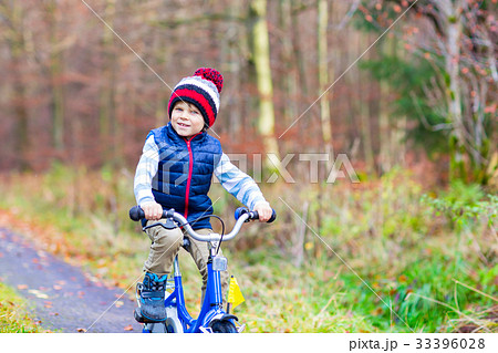 Little kid boy with bicycle in autumn forest Little kid boy with bicycle in autumn forest 33396028