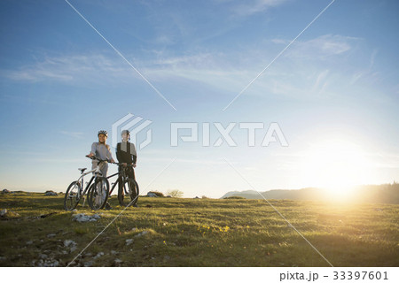 Cyclist couple with mountain bikes standing on the 33397601