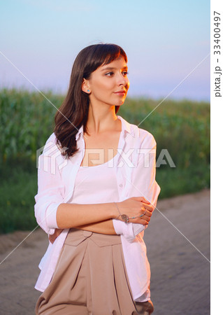 Attractive girl in shirt posing on country road 33400497
