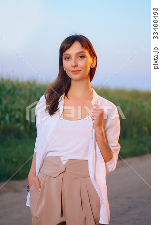 Attractive girl in shirt posing on country road Attractive girl in shirt posing on country road 33400498