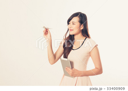 happy woman with airplane model and tablet 33400909