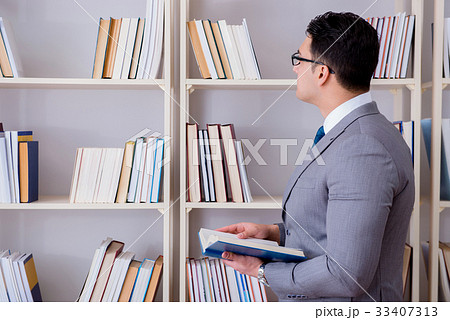 Businessman student reading a book studying in 33407313