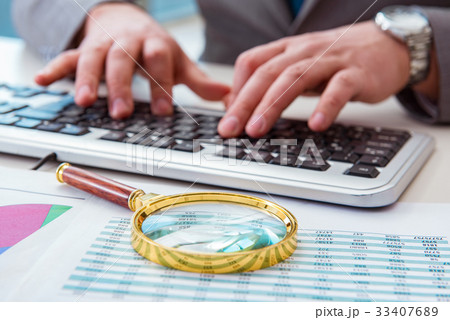 Finance professional working on keyboard with 33407689