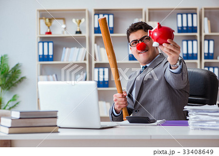 Clown businessman with a baseball bat and a piggy 33408649