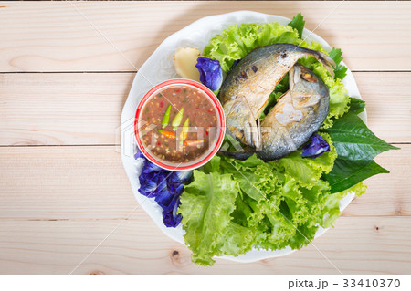 Fried two mackerels with vegetable on white 33410370