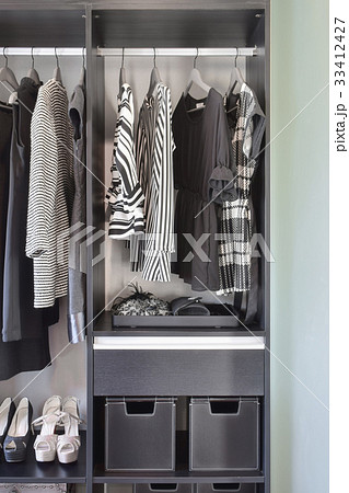 modern closet with row of black dress and shoes modern closet with row of black dress and shoes 33412427