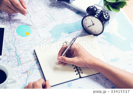 Writing note and consulting for traveling on map Writing note and consulting for traveling on map 33415537