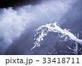 ダム放流と雪積む枝木 33418711