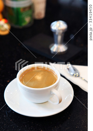 Creammy coffe in white cup with dark background 33419450