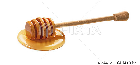 Wooden dipper in honey isolated on white 33423867