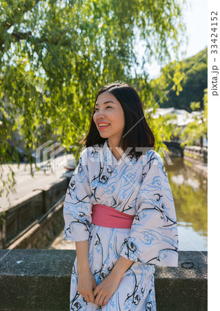 an asian young woman smiling and wearing Yukata 33424152