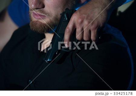 Criminal person pointing gun at the driver 33425178