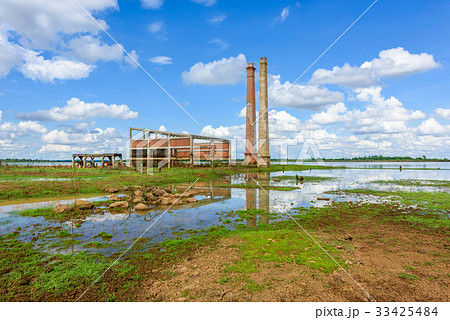 Old mill in the reservoir against blue sky Old mill in the reservoir against blue sky 33425484