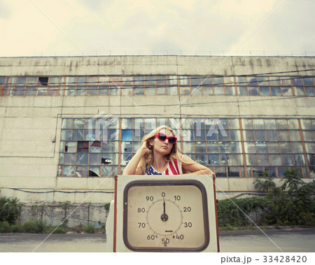 Blond woman on gas station 33428420