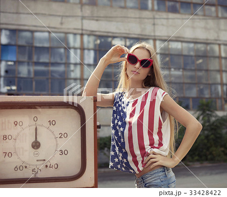 Blond woman on gas station 33428422