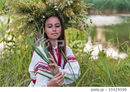 Beautiful girl in embroidery shirt and wreath 33429390
