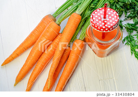 Carrot smoothie in a jar with carrots top view 33430804