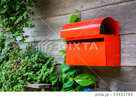 Red mailbox on the wooden wall 33431789