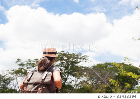 Woman traveler with backpack looking at wonderful Woman traveler with backpack looking at wonderful 33433394