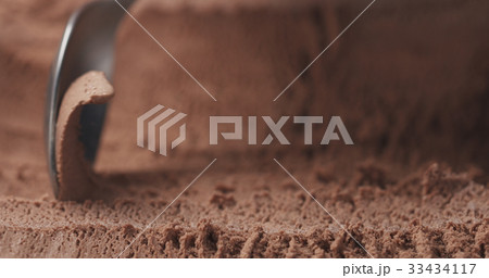 closeup scooping chocolate ice cream with spoon closeup scooping chocolate ice cream with spoon 33434117