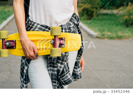 Yellow plastic skateboard with green wheels 33452346