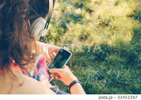 Cropped image of a girl in headphones Cropped image of a girl in headphones 33452397