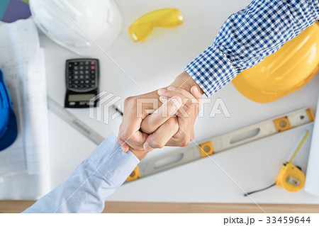 Top view Architect and engineer shaking hands 33459644