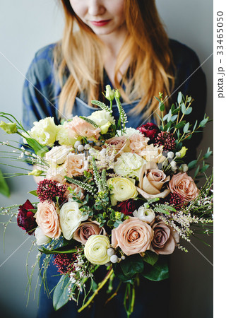 A bouquet of flowers in the hands of a florist A bouquet of flowers in the hands of a florist 33465050
