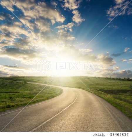 sunset in clouds over asphalt road to horizon 33465352